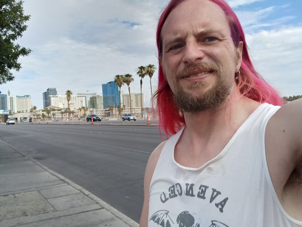 Jack Drago smiles with the skyline of Las Vegas in the background.