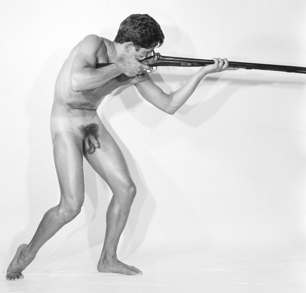 Mark Nixon nude firing a rifle