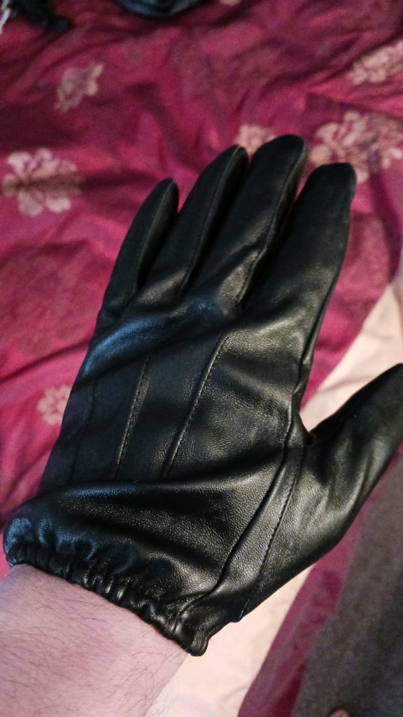 My hands in black leather gloves.