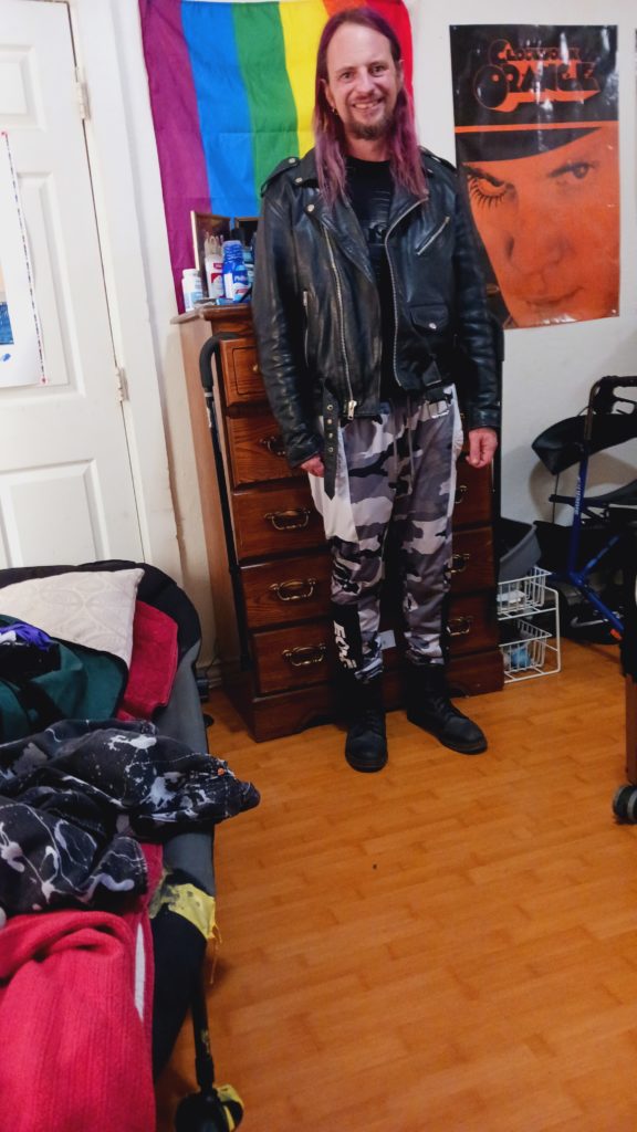 Purple haired Jack Drago in leather jacket and boots