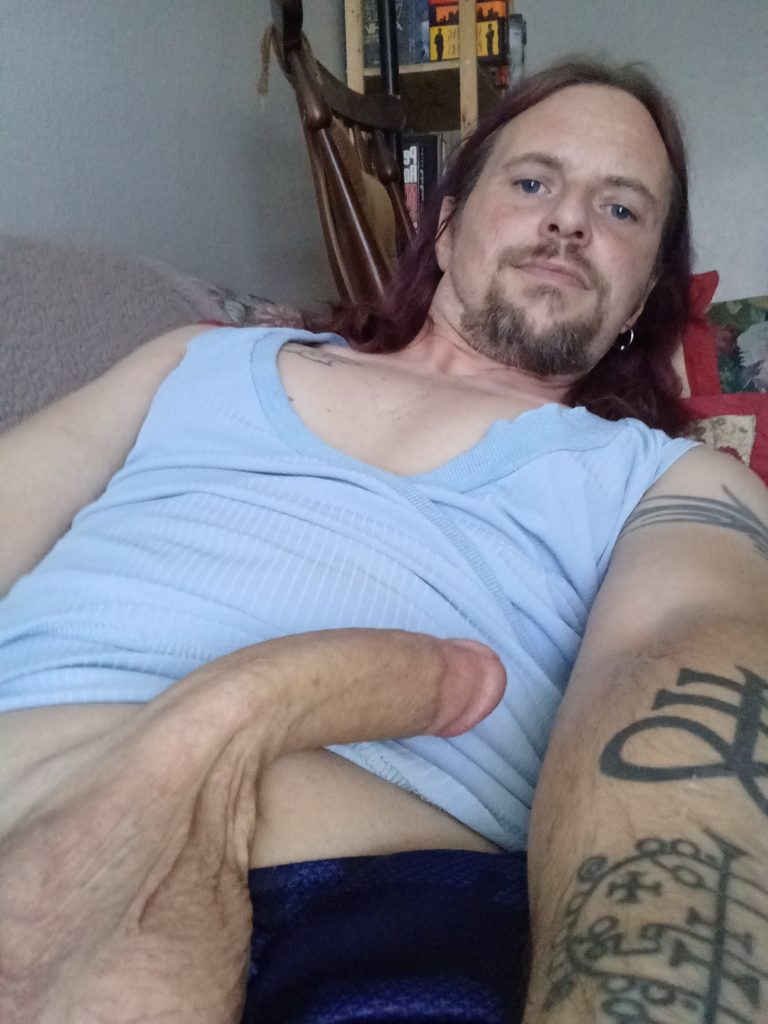 Jack Drago's sigils of Leviathan and Asemodeus are visible in a selfie showing hys erect penis in a blue shirt.