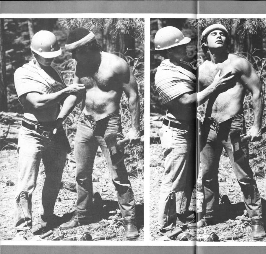 Hiker grabs a forestery worker in a hard hat's cock while holding an axe.