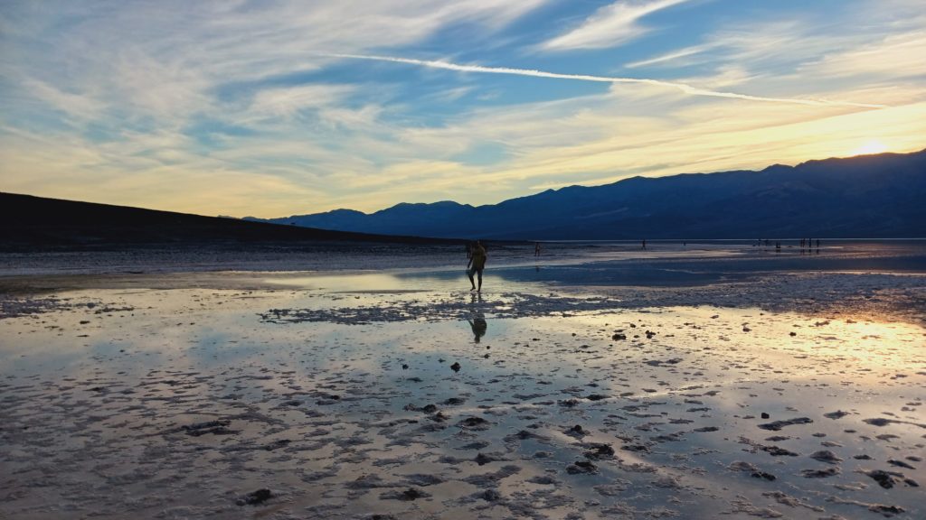 Drawing sigils in the sand at sunset in the shallow waters at the bottom of Badwater basin.