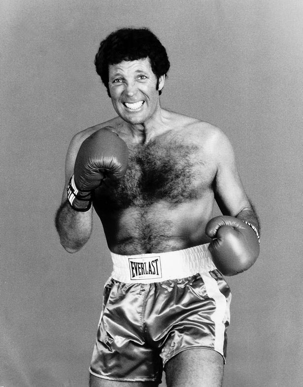 Tom Jones in boxing gloves and trunks.