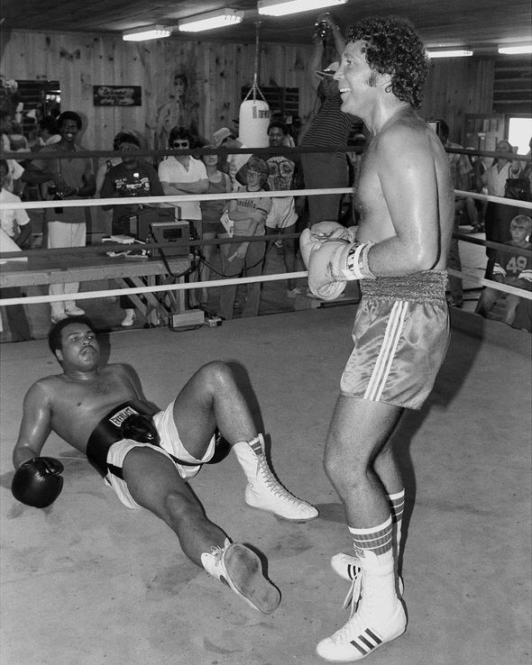 Tom Jones knocks down Muhammad Ali while boxing.