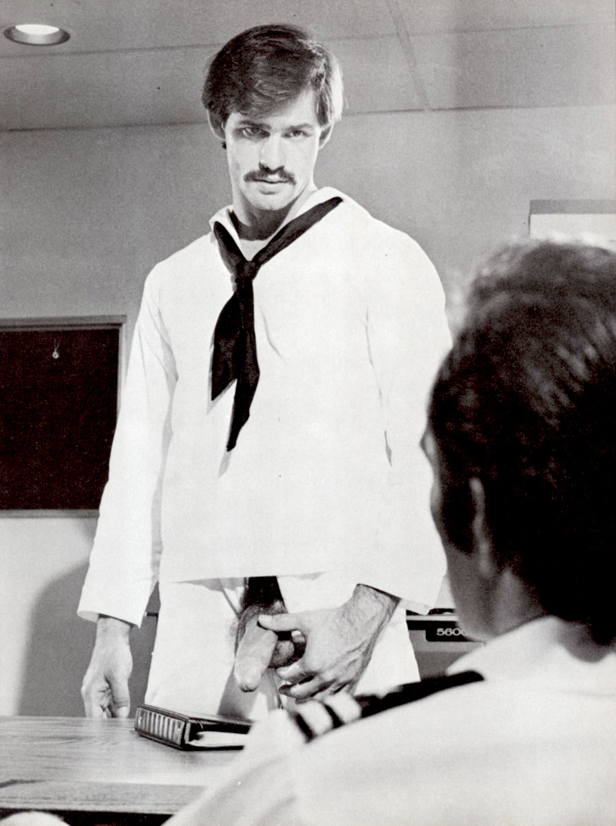 porn star J. W. King in a naval uniform showing his big cock to the officer.