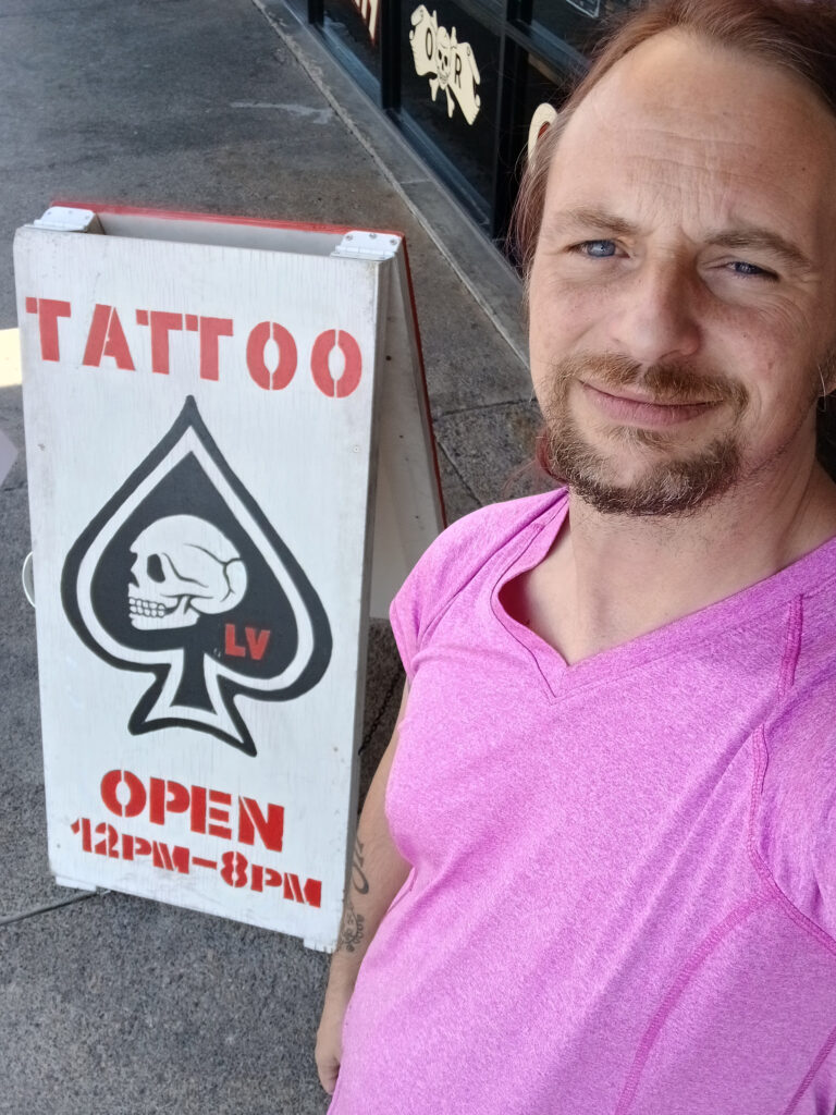 Me outside the tattoo parlor
Sign says Tattoo Open 12pm-8pm