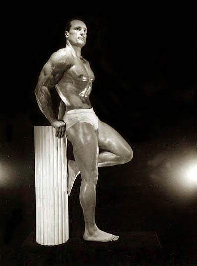 Jack LaLanne on a black backdrop with a white column