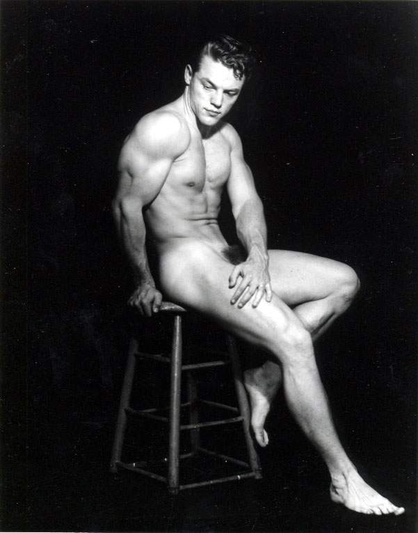 Hugh Pendleton models nude on a stool against Pat Milo's black backdrop